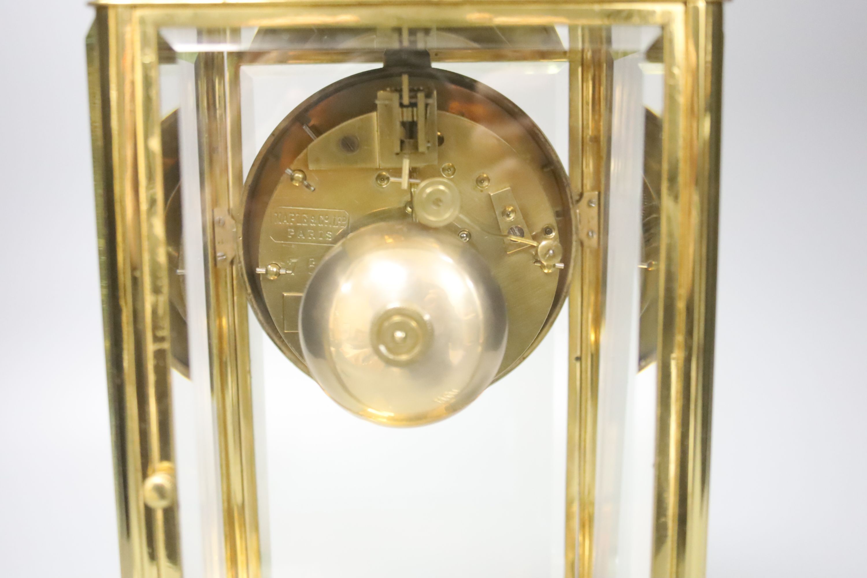 A French brass four glass clock, key and pendulum 27cm